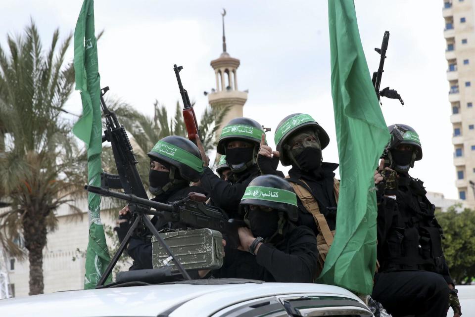 Masked militants from the al-Qassam Brigades, the military wing of Hamas.  / Credit: AP/Adel Hana
