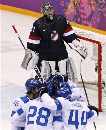 Team USA's goalie Jonathan Quick reacts as Finland's Teemu Selanne (hidden) celebrates his goal with his linemates during the third period of their men's ice hockey bronze medal game at the Sochi 2014 Winter Olympic Games February 22, 2014. REUTERS/Grigory Dukor