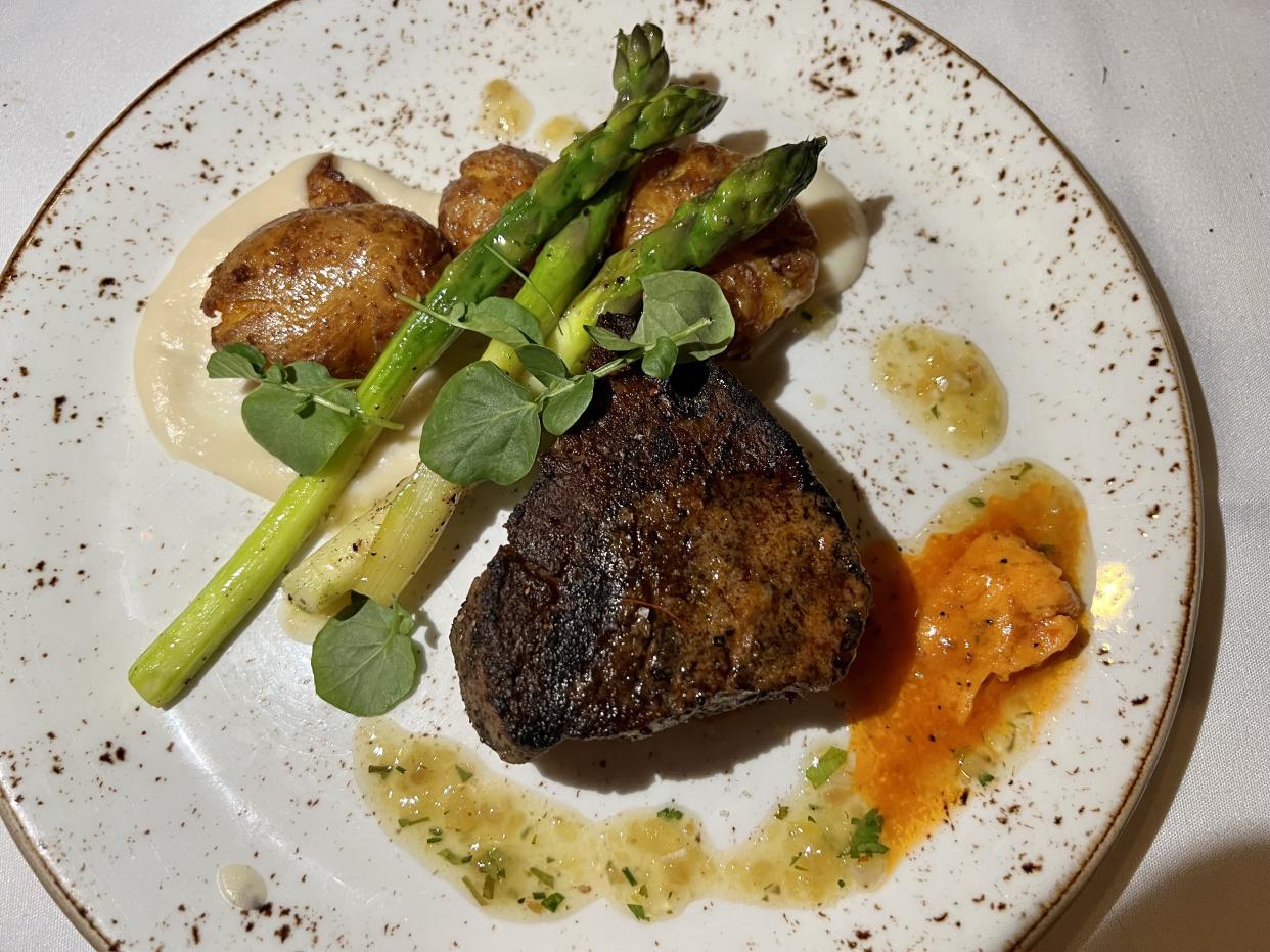Among the best steaks I've had in my life, this filet mignon was topped with tomato butter and served with potatoes, asparagus and cauliflower puree. (Photo: Terri Peters)