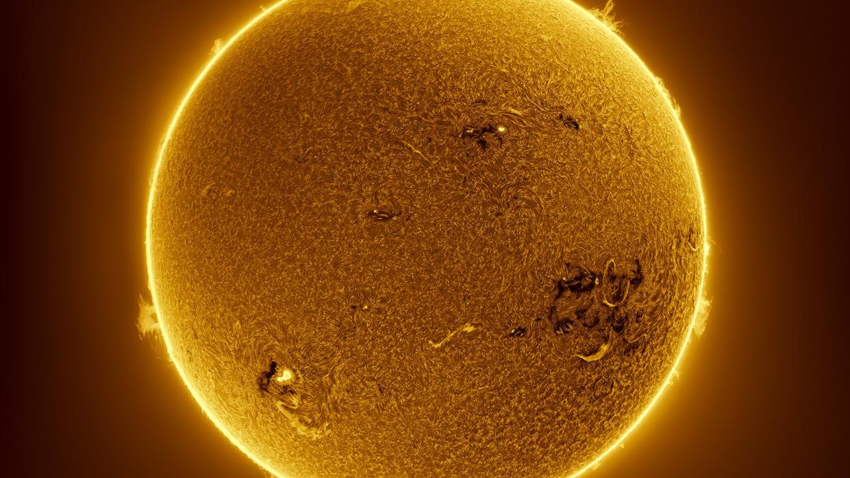  The raging fire of the sun is seen in great detail. Solar flares erupt from its surface and around its edges. 