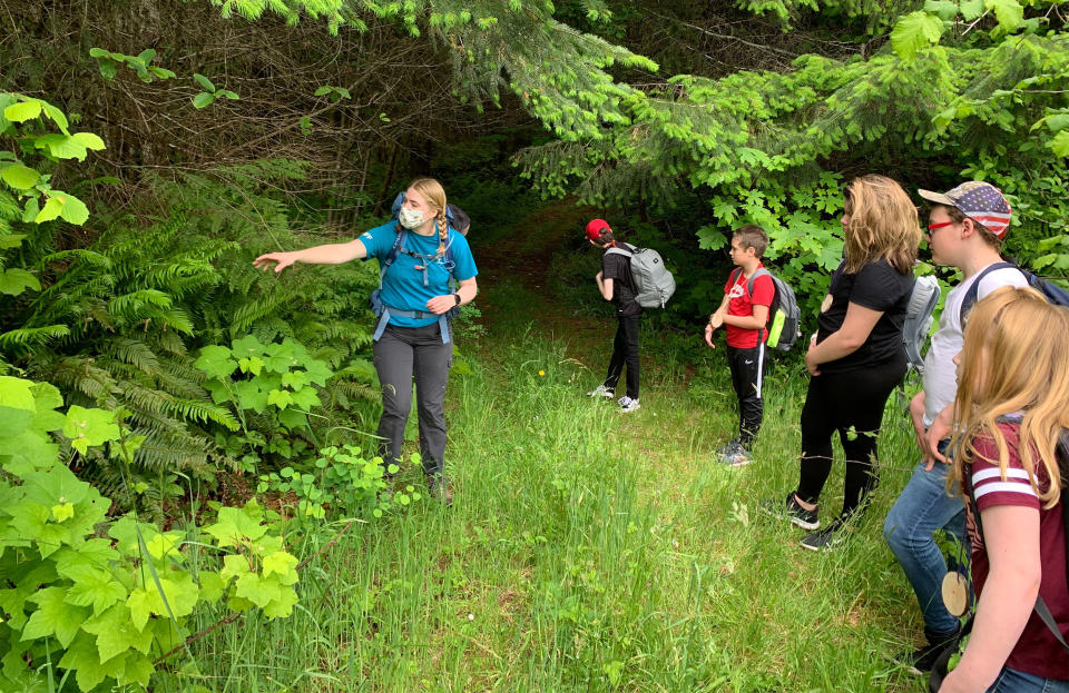 Campers and a counselor in a face mask go on a socially-distanced nature hike at Camp Wilani in Veneta, Oregon. (Camp Wilani)