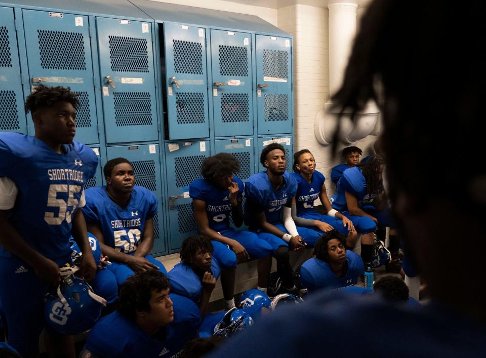 Shortridge players listen to Coach Jovan McCray’s speech during halftime Friday, Aug. 26, 2022, at Shortridge High School in Indianapolis. 