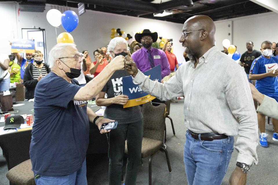 FILE - Senator Raphael Warnock greets the crowd during a rally in Atlanta, on July 23, 2022. Warnock has committed to three debates with Republican U.S. Senate candidate Herschel Walker, but Walker has now chosen a separate, fourth debate before the November election. (Bob Andres/Atlanta Journal-Constitution via AP, FFile)