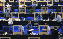 Votes are counted for the Scottish Parliamentary Elections at the Emirates Arena,in Glasgow, Scotland, Saturday May 8, 2021. (Jane Barlow/PA via AP)