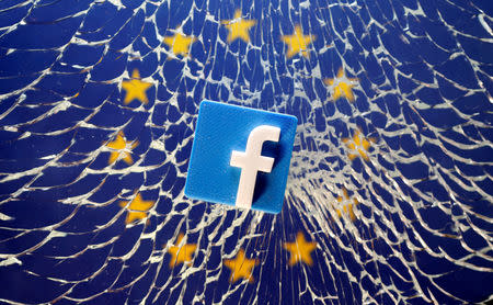 FILE PHOTO: A 3D printed Facebook logo is placed on broken glass above a printed EU flag in this illustration taken January 28, 2019. REUTERS/Dado Ruvic/Illustration/File Photo