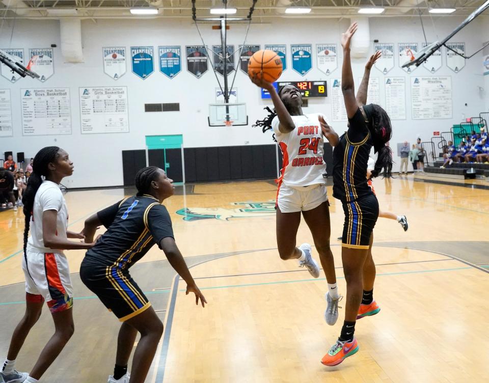 Spruce Creek's Yanija Lawson (24) attempts to shoot over Mainland's Jade Parks (2) during the Five Star Conference Tournament finals at Atlantic High School in Port Orange, Friday, Jan. 26, 2024.