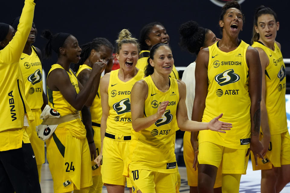 The Seattle Storm celebrate after the team defeated the Minnesota Lynx during Game 3 of a WNBA basketball semifinal round playoff series Sunday, Sept. 27, 2020, in Bradenton, Fla. The Storm move onto the WNBA finals. (AP Photo/Chris O'Meara)