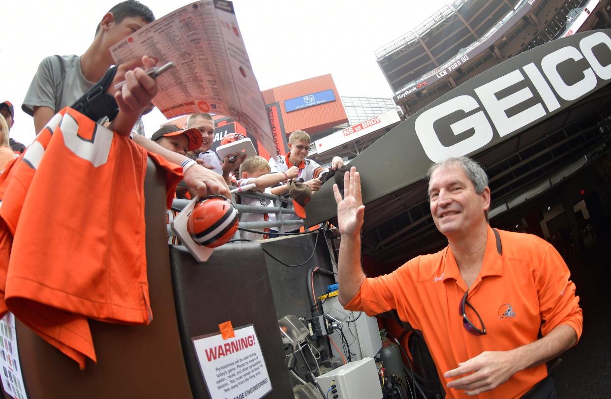 Former Cleveland Browns quarterback Bernie Kosar gives a high-five before an NFL football game between the Cleveland Browns and the Baltimore Ravens, Sunday, Oct. 7, 2018, in Cleveland. (AP Photo/David Richard)