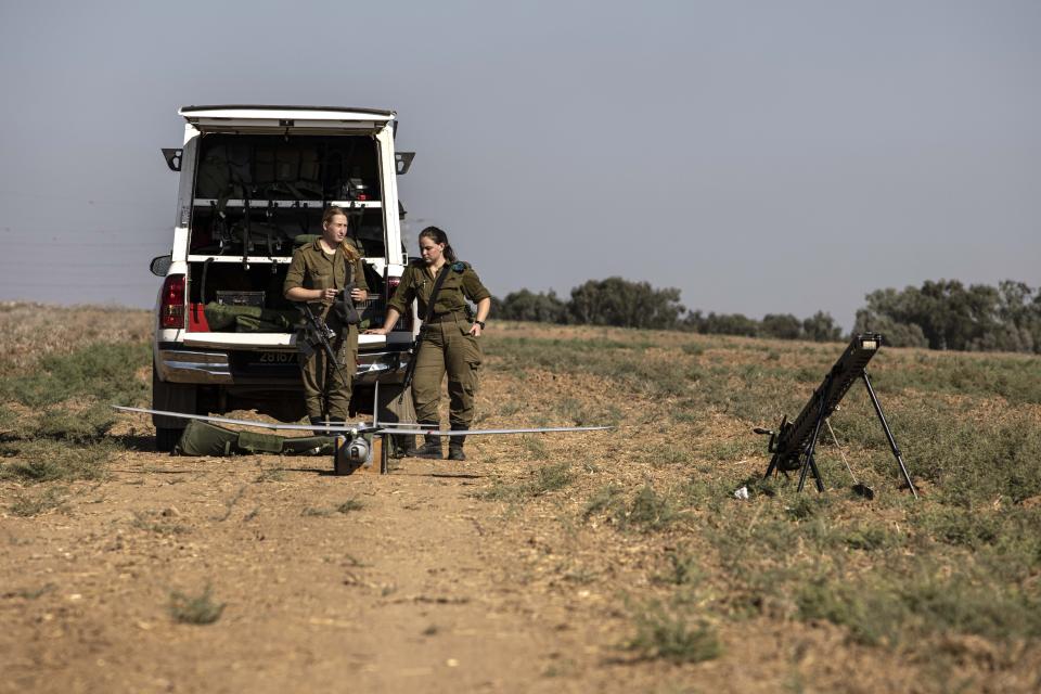 Israeli soldiers prepare to launch a drone near the border with Gaza Strip, Friday, Aug. 21, 2020. The Israeli military says Palestinian militants fired 12 rockets at Israel from the Gaza Strip overnight, nine of which were intercepted. (AP Photo/Tsafrir Abayov)