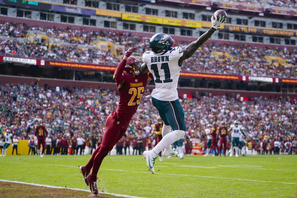 Philadelphia Eagles wide receiver A.J. Brown (11) making a one-handed catch to score a touchdown against Washington Commanders cornerback Benjamin St-Juste (25) during the first half of an NFL football game, Sunday, Oct. 29, 2023, in Landover, Md. (AP Photo/Alex Brandon)