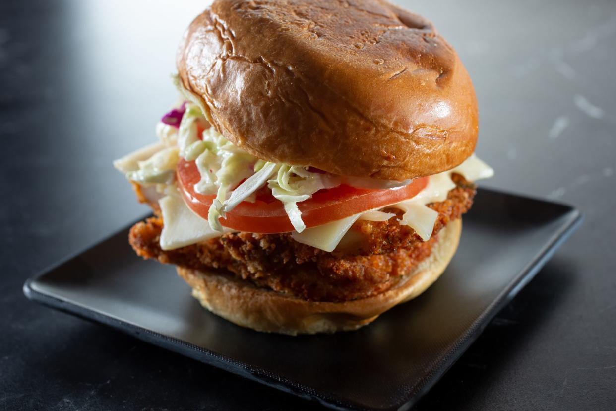 A Nashville Chicken Sandwich on a Black Square Plate