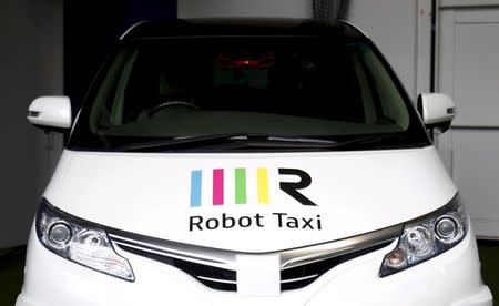 The company logo of Robot Taxi Inc. is seen on the hood of a Robot Taxi, a self-driving taxi based on a Toyota Estima car body, during an unveiling ceremony in Yokohama, south of Tokyo, Japan, in this October 1, 2015 file photo. REUTERS/Yuya Shino/Files