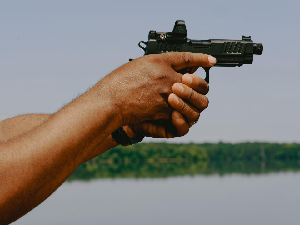 Philip Smith holds a handgun. (Peyton Fulford for NBC News)