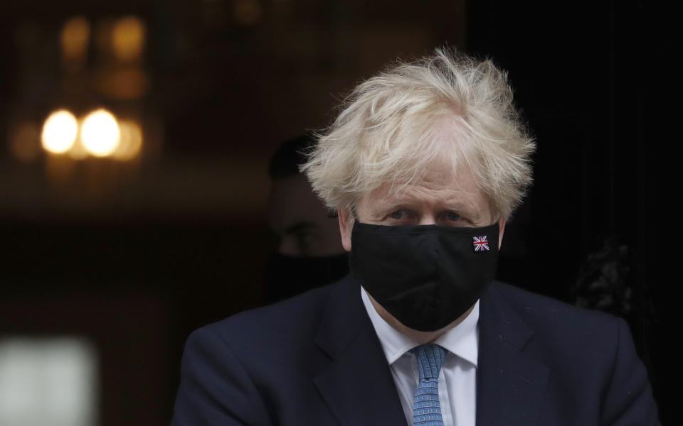 Britain's Prime Minister Boris Johnson leaves 10 Downing Street for a debate on the Queen Speech at House of Commons in London, Wednesday, May 12, 2021. (AP Photo/Alastair Grant)