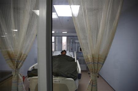 Dawa Tashi Sherpa lies on the bed of the Intensive Care Unit at Grandi International Hospital after he was rescued and airlifted from the avalanche site at Mount Everest in Kathmandu April 18, 2014. REUTERS/Navesh Chitrakar