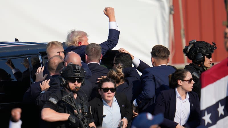 Republican presidential candidate former President Donald Trump is escorted to a motorcade following an attempted assassination at a campaign event in Butler, Pa., on Saturday, July 13, 2024.