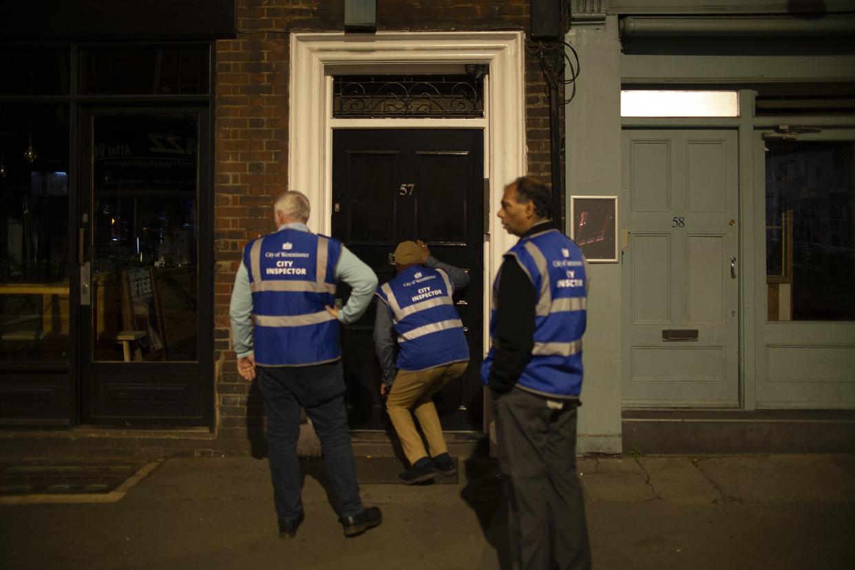 COVID inspectors peer through pub doors tlooking for lock-ins as the country begins its 10pm curfew for bars and restaurants - measures which could last up to six months (Dan Barker/Twitter)