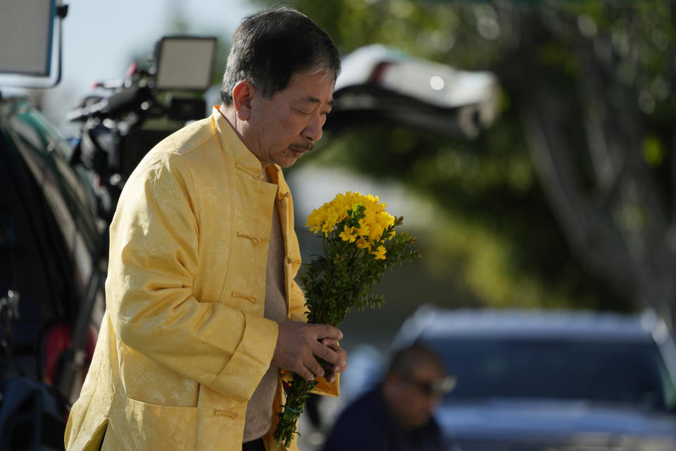 A man lays down flowers at a memorial outside the Star Ballroom Dance Studio on Monday, Jan. 23, 2023, in Monterey Park, Calif. A gunman killed multiple people at the ballroom dance studio late Saturday amid Lunar New Year's celebrations in the predominantly Asian American community. (AP Photo/Ashley Landis)