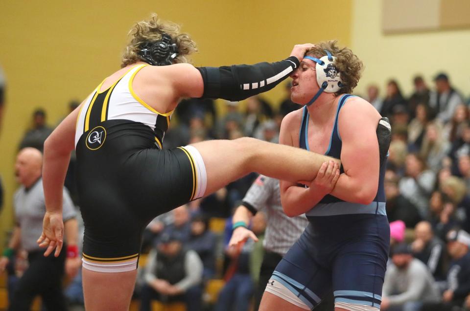 Quaker Valley's Chase Kretzler (black) attempts to push away from Burrell's Luke Boylan (blue) during their 215 pound match while competing in the WPIAL 2A Wrestling Team Semifinals Saturday afternoon at Chartiers-Houston High School in Houston, PA.