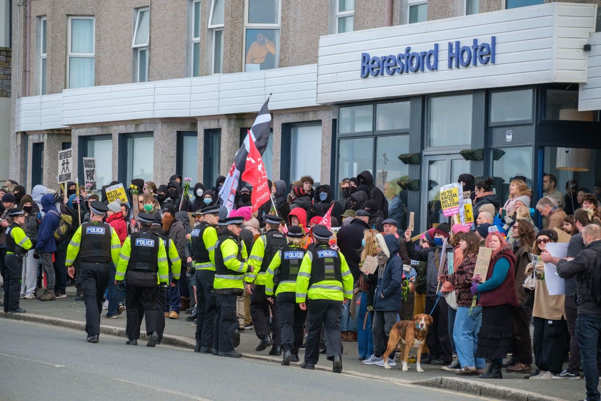 A protest outside a hotel used to house asylum seekers in Cornwall  (PA)