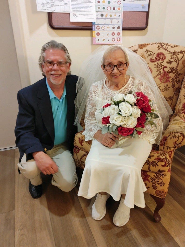 Rob Geiger poses with Dottie Fideli on her wedding day, May 13, 2023. Geiger officiated the wedding where Fideli married herself.