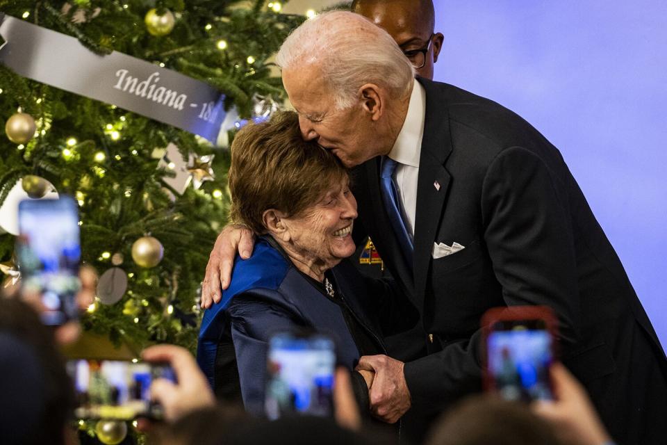 US President Joe Biden hugs Bronia Brandman, who is a Holocaust Survivor and retired public-school teacher, before lightings the menorah during a Hanukkah Holiday Reception