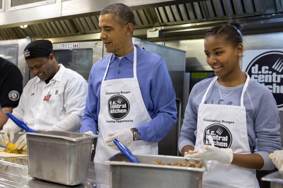 President Barack Obama and his daughter Sasha make burritos at D.C. Central Kitchen as part of a service project in honor of Martin Luther King, Jr. Day,  Monday, Jan. 20, 2014, in Washington. 