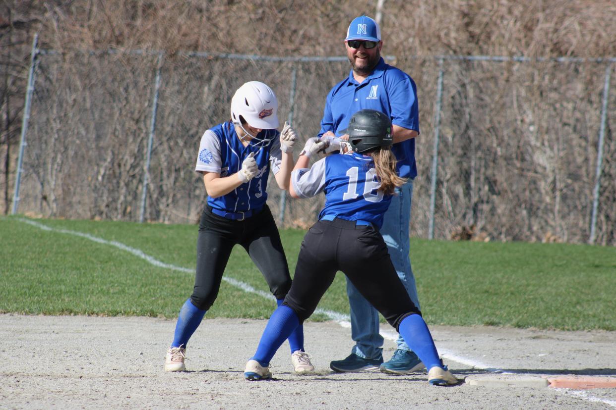 Mia and Gianna Manca jokingly box each other during a timeout in Narragansett Regional's game on April 16, 2024.