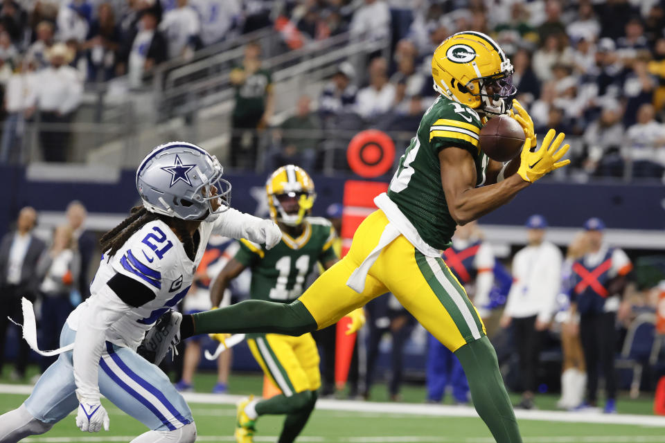 Green Bay Packers wide receiver Dontayvion Wicks, right, makes a touchdown catch in front of Dallas Cowboys cornerback Stephon Gilmore during the first half of an NFL football game, Sunday, Jan. 14, 2024, in Arlington, Texas. (AP Photo/Michael Ainsworth)