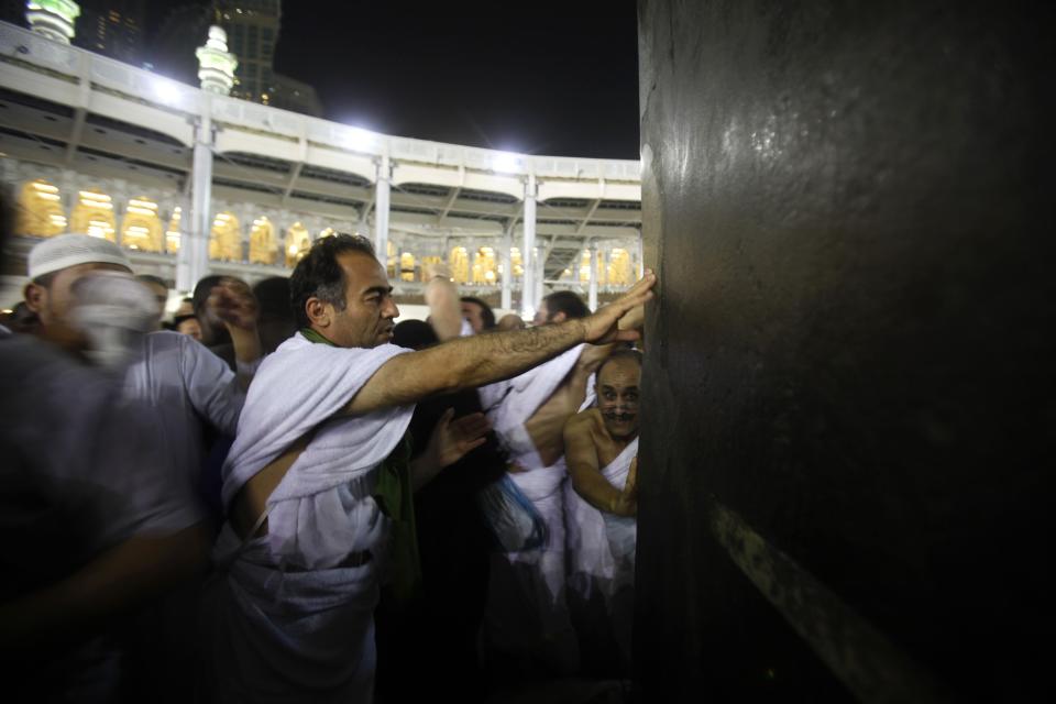 Muslim pilgrims touch the Kaaba at the Grand Mosque in the holy city of Mecca ahead of the annual Haj pilgrimage