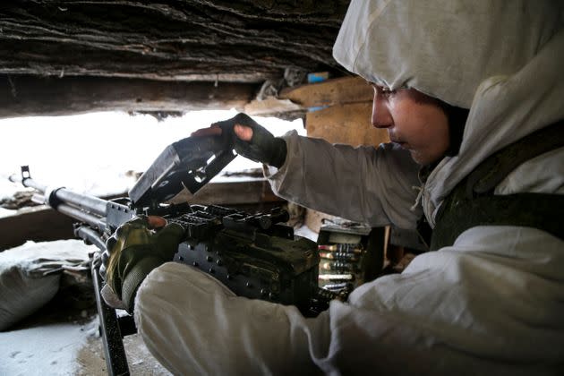A serviceman checks his machine-gun in a shelter on the territory controlled by pro-Russian militants at frontline with Ukrainian government forces in Slavyanoserbsk, Luhansk region, eastern Ukraine, Tuesday, Jan. 25, 2022. (AP Photo/Alexei Alexandrov) (Photo: via Associated Press)