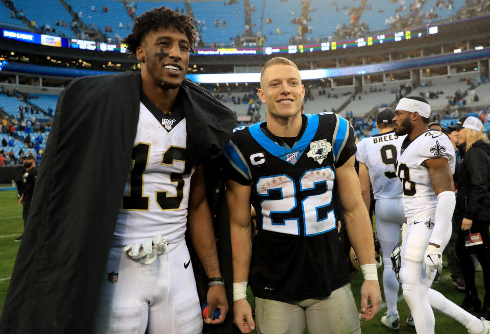 CHARLOTTE, NORTH CAROLINA - DECEMBER 29: Michael Thomas #13 of the New Orleans Saints poses for a picture with Christian McCaffrey #22 of the Carolina Panthers after their game at Bank of America Stadium on December 29, 2019 in Charlotte, North Carolina. (Photo by Streeter Lecka/Getty Images)