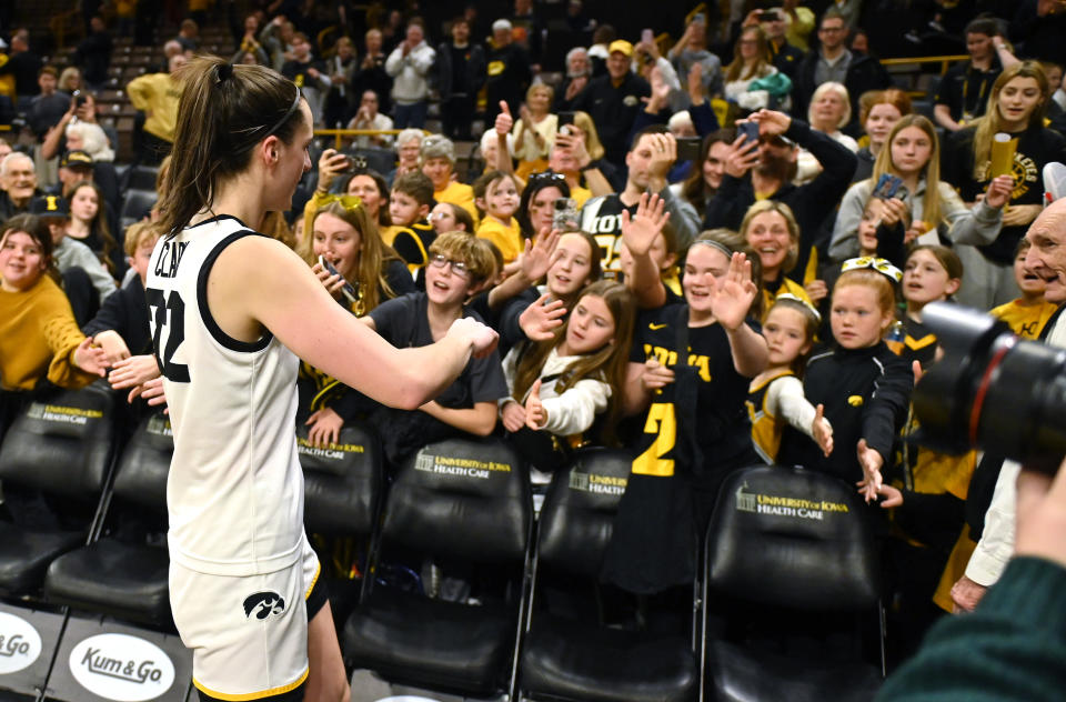 Iowa's Caitlin Clark signs autographs for fans after a regular season game.  (Keith Gillette/Icon Sportswire via Getty Images)