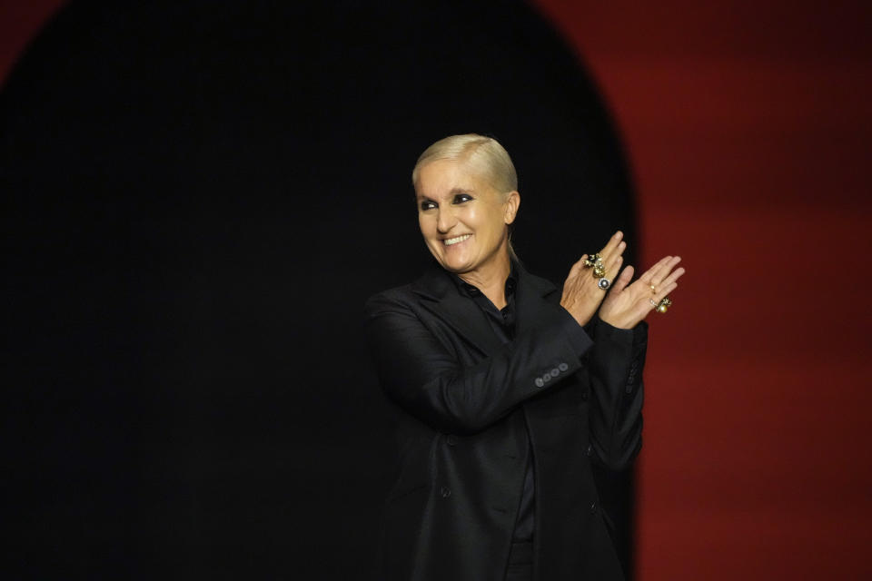 Maria Grazia Chiuri acknowledges applause after the Dior Spring-Summer 2022 ready-to-wear fashion show presented Tuesday, Sept. 28, 2021, in Paris. (AP Photo/Francois Mori)