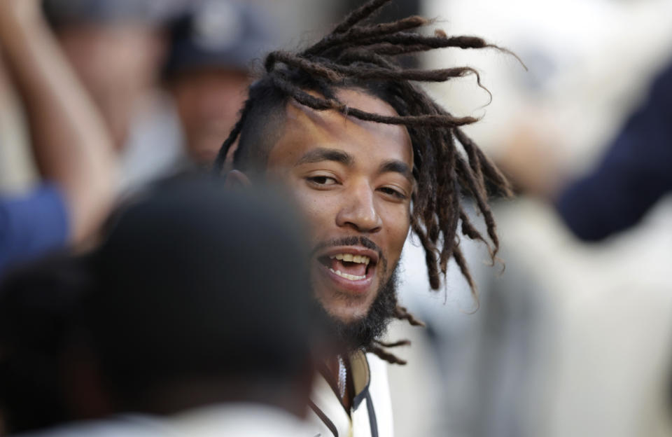 Seattle Mariners' J.P. Crawford celebrates in the dugout after hitting a grand slam off Tampa Bay Rays starting pitcher Josh Fleming during the second inning of a baseball game Saturday, June 19, 2021, in Seattle. (AP Photo/John Froschauer)