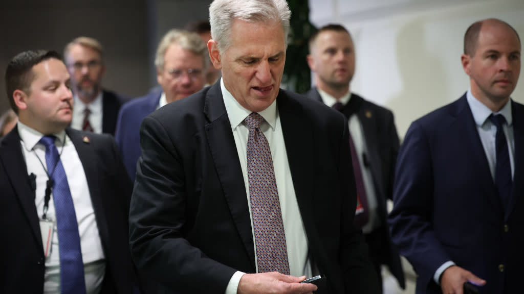  House Speaker Kevin McCarthy checks his phone. 