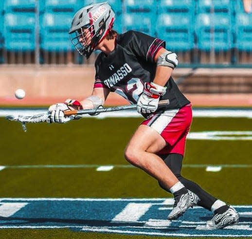Bartlesville High's Duke McGill — playing for the state championship Owasso Lacrosse Club team — bursts away from the face-off with the rock (ball) .
