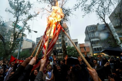 Iranians burn US flags during an anti-US demonstration outside the former US embassy headquarters in the capital Tehran on May 9, 2018