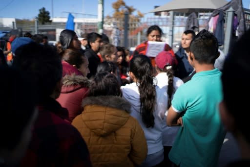 A woman from Guererro State who is in charge of the "ficha," or the list system used for asylum seekers waiting to cross into the US, gathers money to pay for newly issued cards