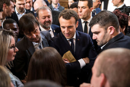 French President Emmanuel Macron (C) speaks with guests next to Minister of the Ecological and Social Transition Nicolas Hulot (L) and French President of the Young Farmers Association Jeremy Decerle (R) after he delivered a speech to the young French farmers invited at the Elysee Palace before the opening of the 2018 Paris International Agricultural Show in Paris, France, February 22, 2018. REUTERS/Etienne Laurent/Pool