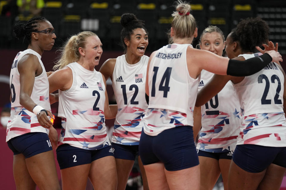 United States teammates celebrate winning a point during the women's volleyball preliminary round pool B match between China and United States at the 2020 Summer Olympics, Tuesday, July 27, 2021, in Tokyo, Japan. (AP Photo/Frank Augstein)