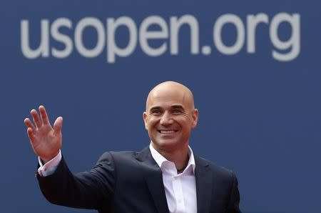 FILE PHOTO: Two-time U.S. Open champion Andre Agassi waves before being inducted into the U.S. Open Court of Champions, which celebrates the legacy of the greatest singles champions in the history of the tournament, in New York September 9, 2012. REUTERS/Kevin Lamarque