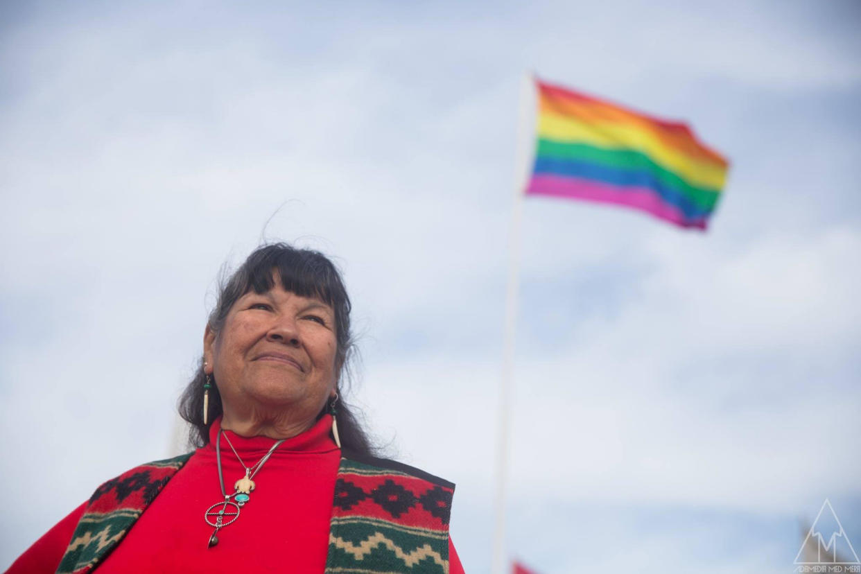 Beverly Little Thunder standing by two-spirit&nbsp;flag at Standing Rock #NoDAPL resistance camp. (Photo: Adam Johansson)