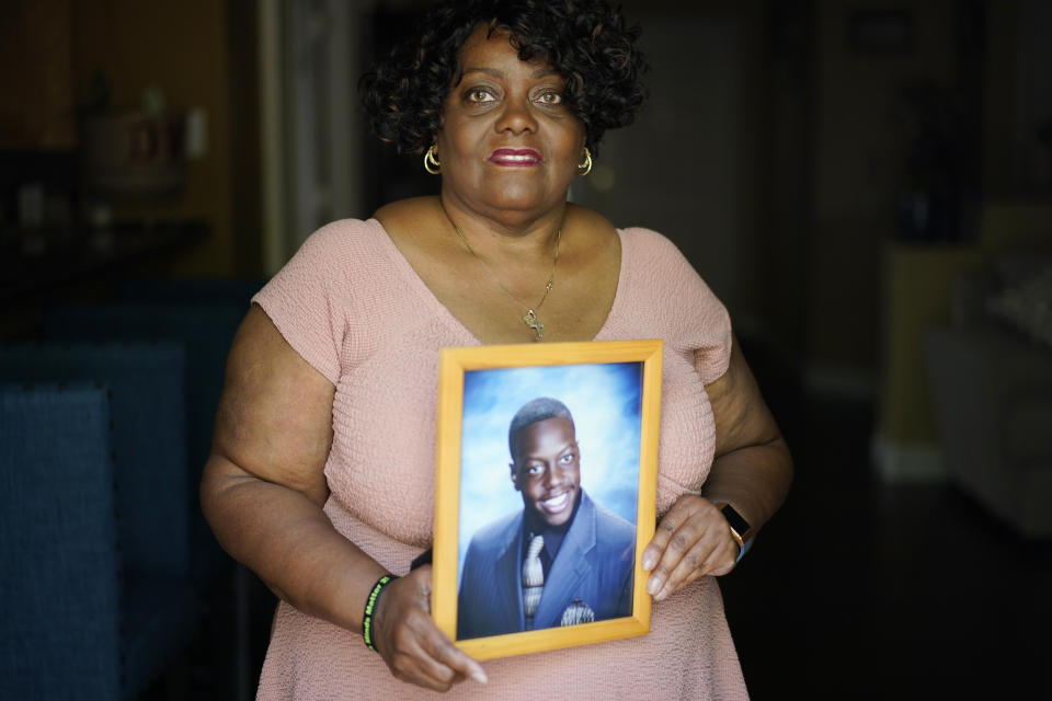 Diane Wilson holds a photo of her son Tyrell Wilson, Wednesday, May 5, 2021, in North Las Vegas, who was was shot and killed by Police Officer Andrew Hall in Danville, Calif., on March 11. Two fatal shootings by Hall in the wealthy San Francisco suburb have cast a spotlight on what criminal justice activists are calling a case of delayed justice and its deadly consequences. (AP Photo/John Locher)