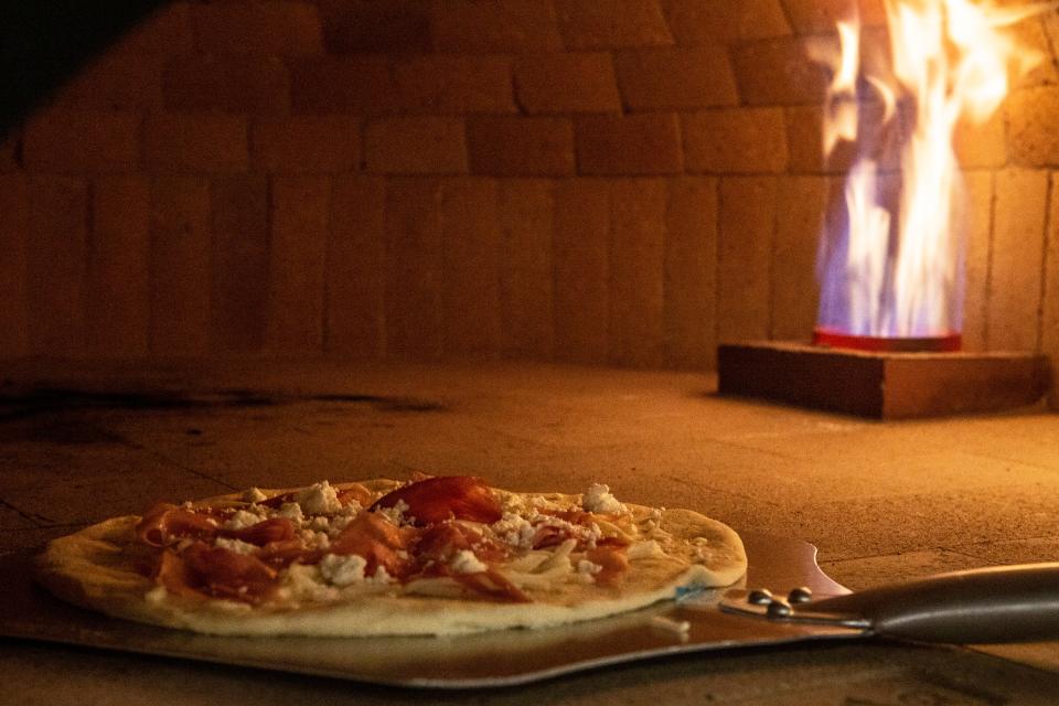 A pizza is placed in the oven at Toscana one of the food kiosks at The Chancery Market in Wilmington, Wednesday, Nov. 30, 2022. The eatery has since closed.