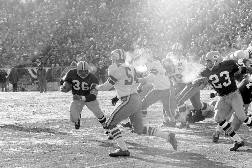 Packers fullback Ben Wilson (36) carries the ball during the NFL Championship Game, Dec. 31, 1967, at Lambeau Field. Also pictured are Packers running back Travis Williams (23) and Cowboys linebacker Chuck Howley (54).