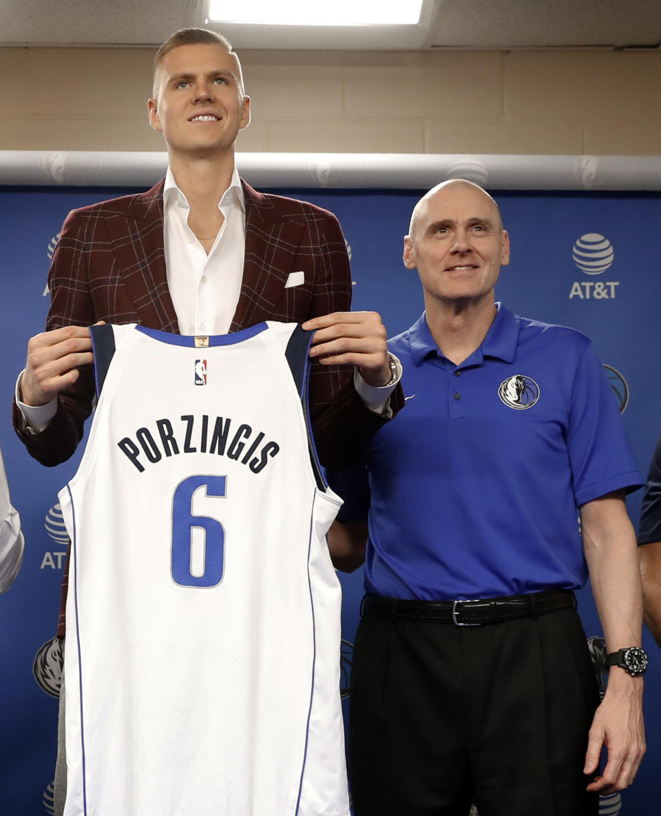 Kristaps Porzingis poses for a photo with Dallas Mavericks head coach Rick Carlisle after a news conference where he and the other newly acquired players were introduced in Dallas, Monday, Feb. 4, 2019. (AP Photo/Tony Gutierrez)