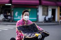 A woman wearing a mask is seen in downtown Shanghai
