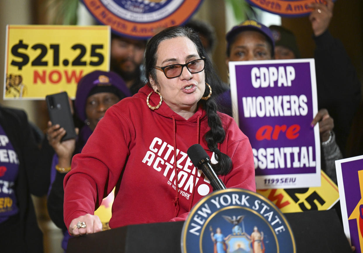 Rosemarry Rivera, of Citizen Action of New York, stands with protesters urging lawmakers to raise New York's minimum wage during a rally at the state Capitol, Monday, March 13, 2023, in Albany, N.Y. (AP Photo/Hans Pennink)