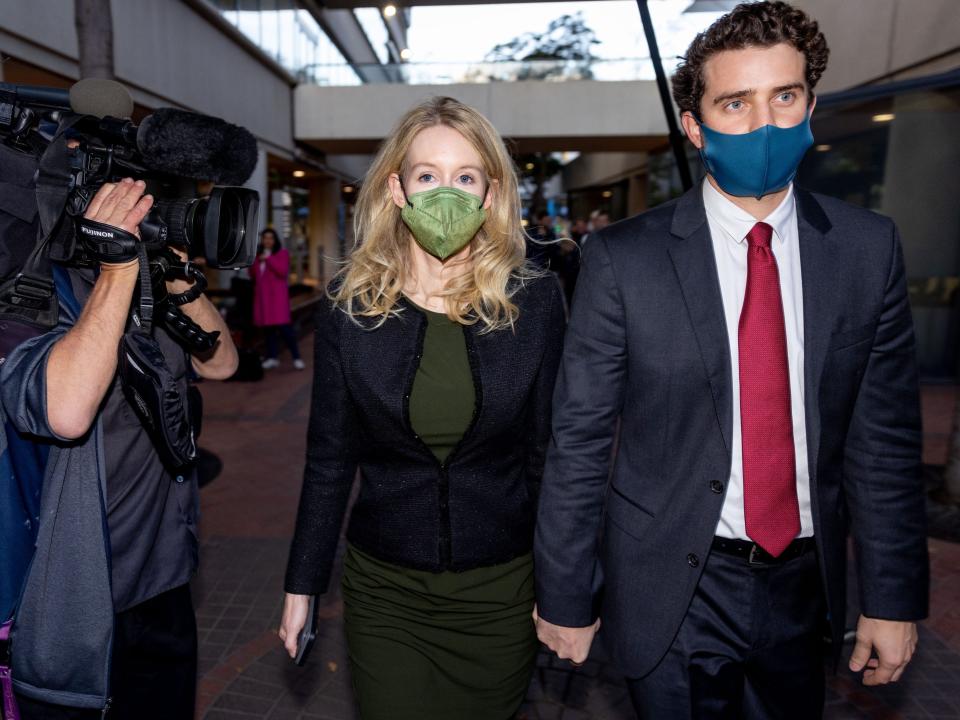 Theranos founder and former CEO Elizabeth Holmes along with her partner Billy Evans (R) leave the Robert F. Peckham Federal Building on November 23, 2021 in San Jose, California. Holmes is facing charges of conspiracy and wire fraud for allegedly engaging in a multimillion-dollar scheme to defraud investors with the Theranos blood testing lab services.